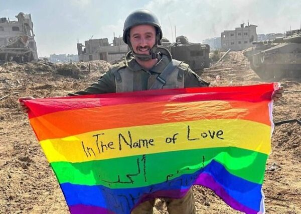 Gay Israeli soldier unfurls LGBTQ+ flag in Gaza